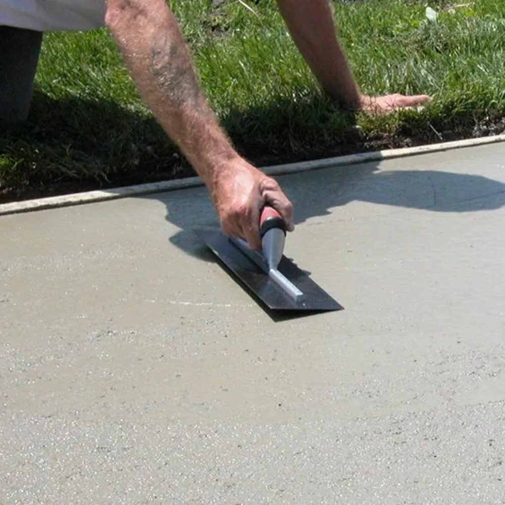 Close-up of a trowel finishing a concrete slab