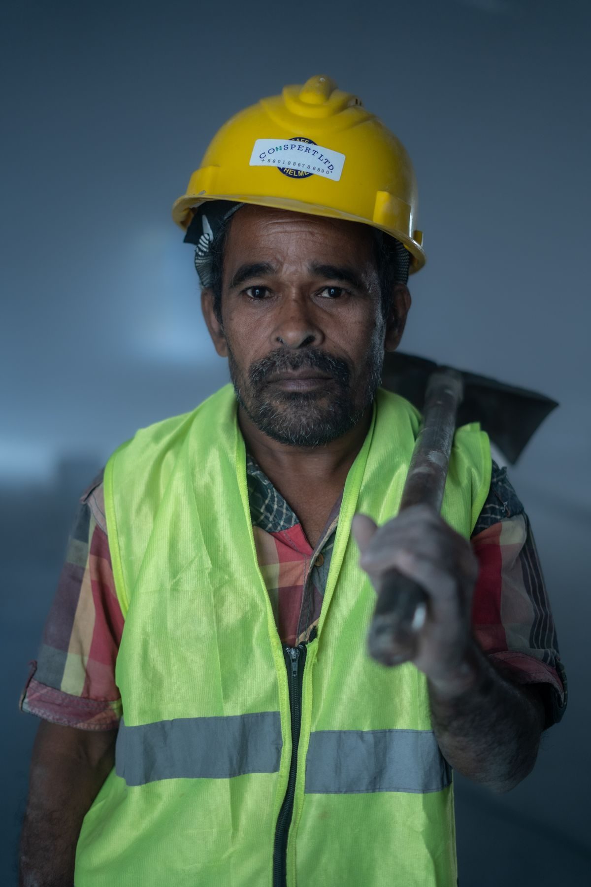 Construction worker in hard hat and high-visibility vest on site