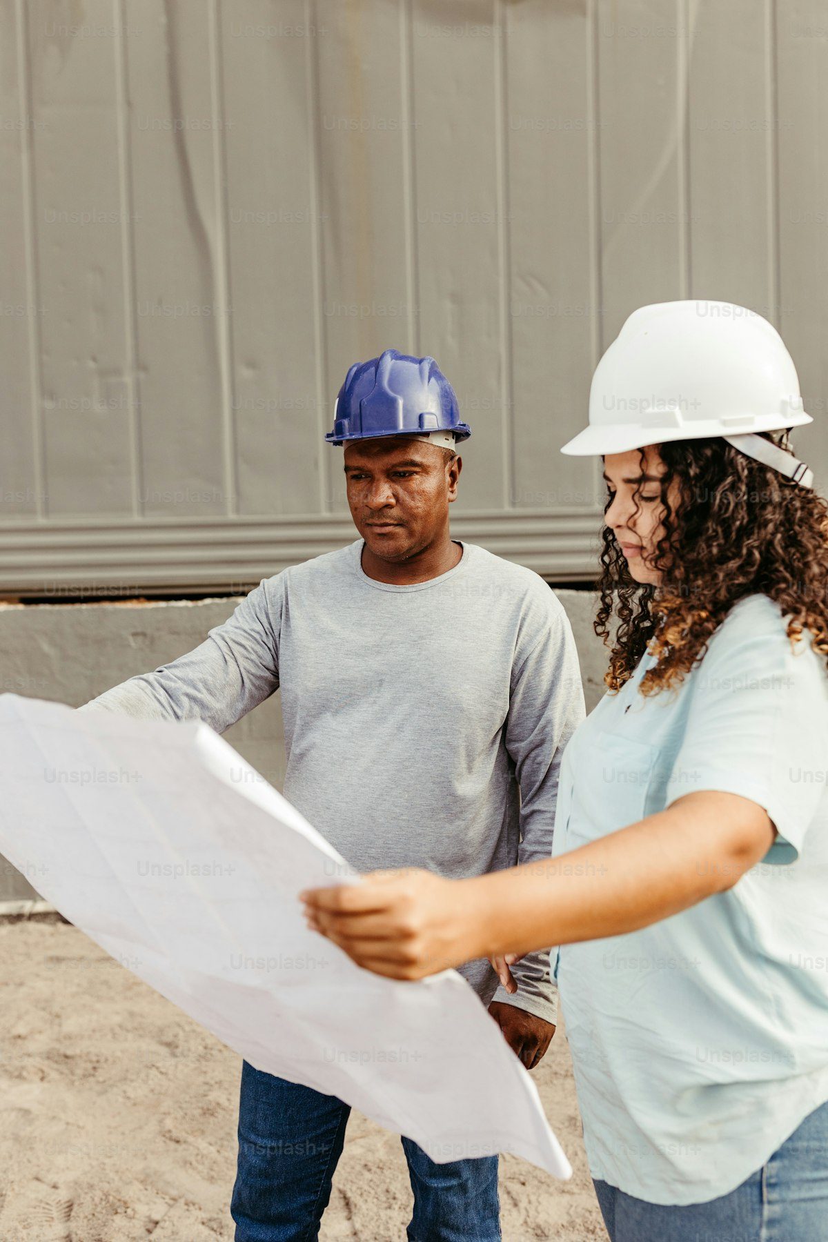 Engineer and architect reviewing drawings on site